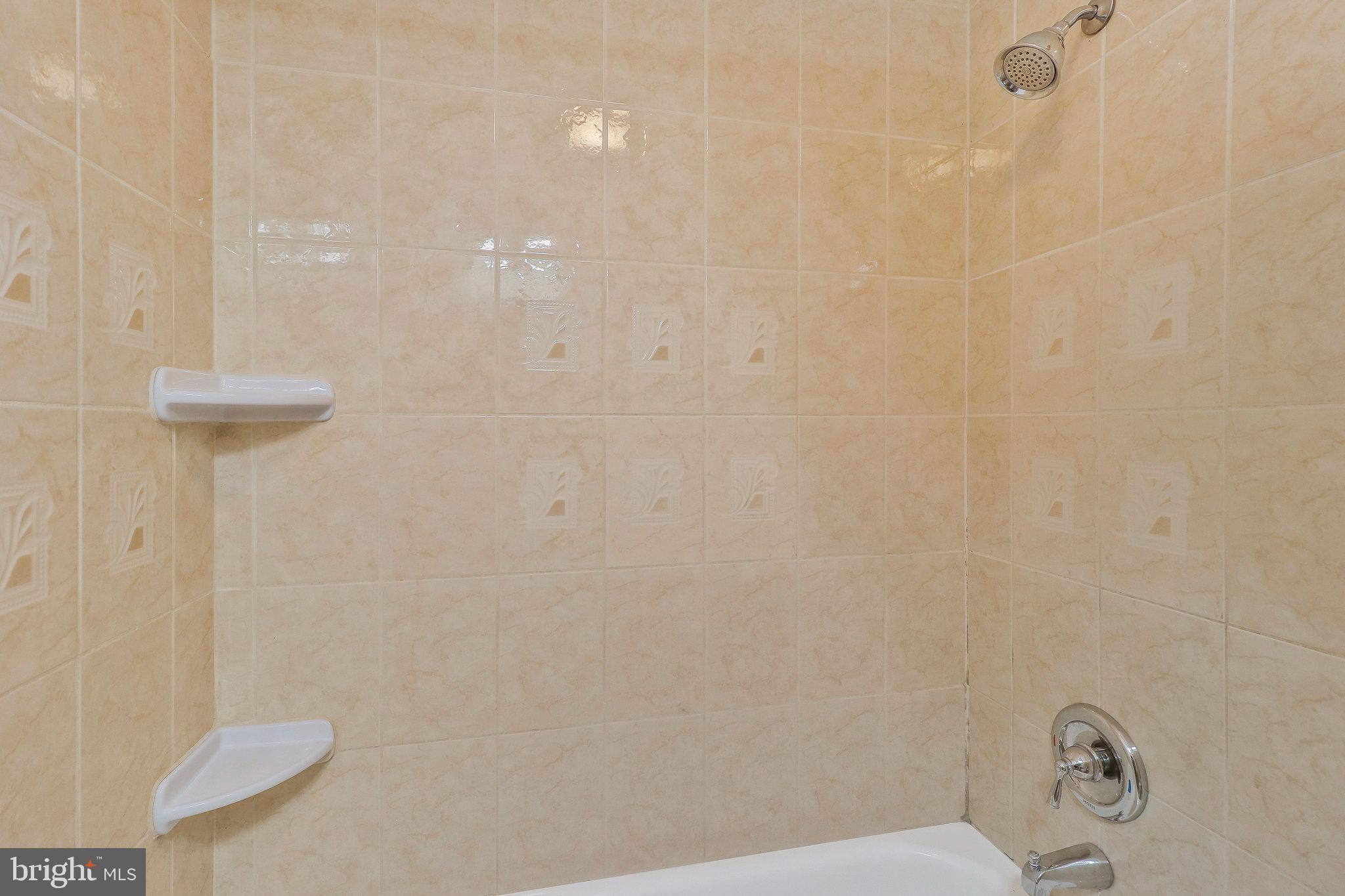 9600 Woodland Avenue Lanham, MD 20706 - Photo 36 of 41 a bathroom with a shower and a toilet