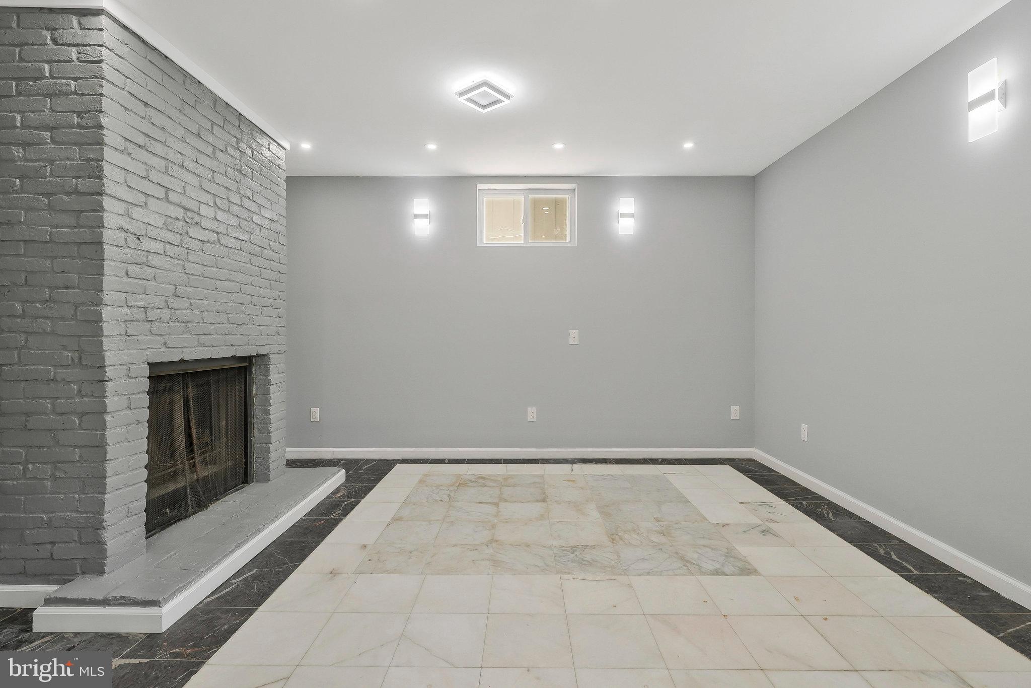9600 Woodland Avenue Lanham, MD 20706 - Photo 37 of 41 a view of an empty room with a fireplace