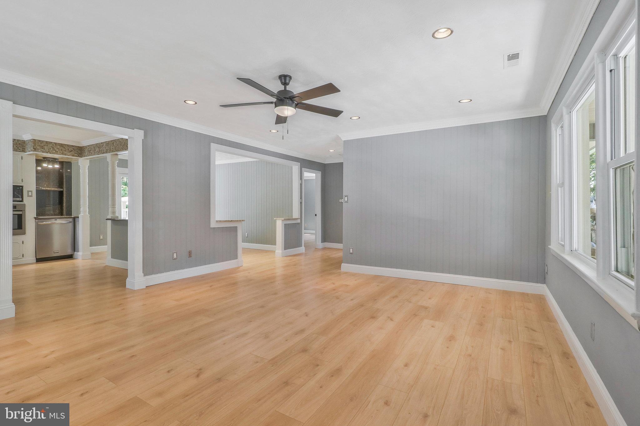 9600 Woodland Avenue Lanham, MD 20706 - Photo 4 of 41 a view of an empty room with wooden floor and a window