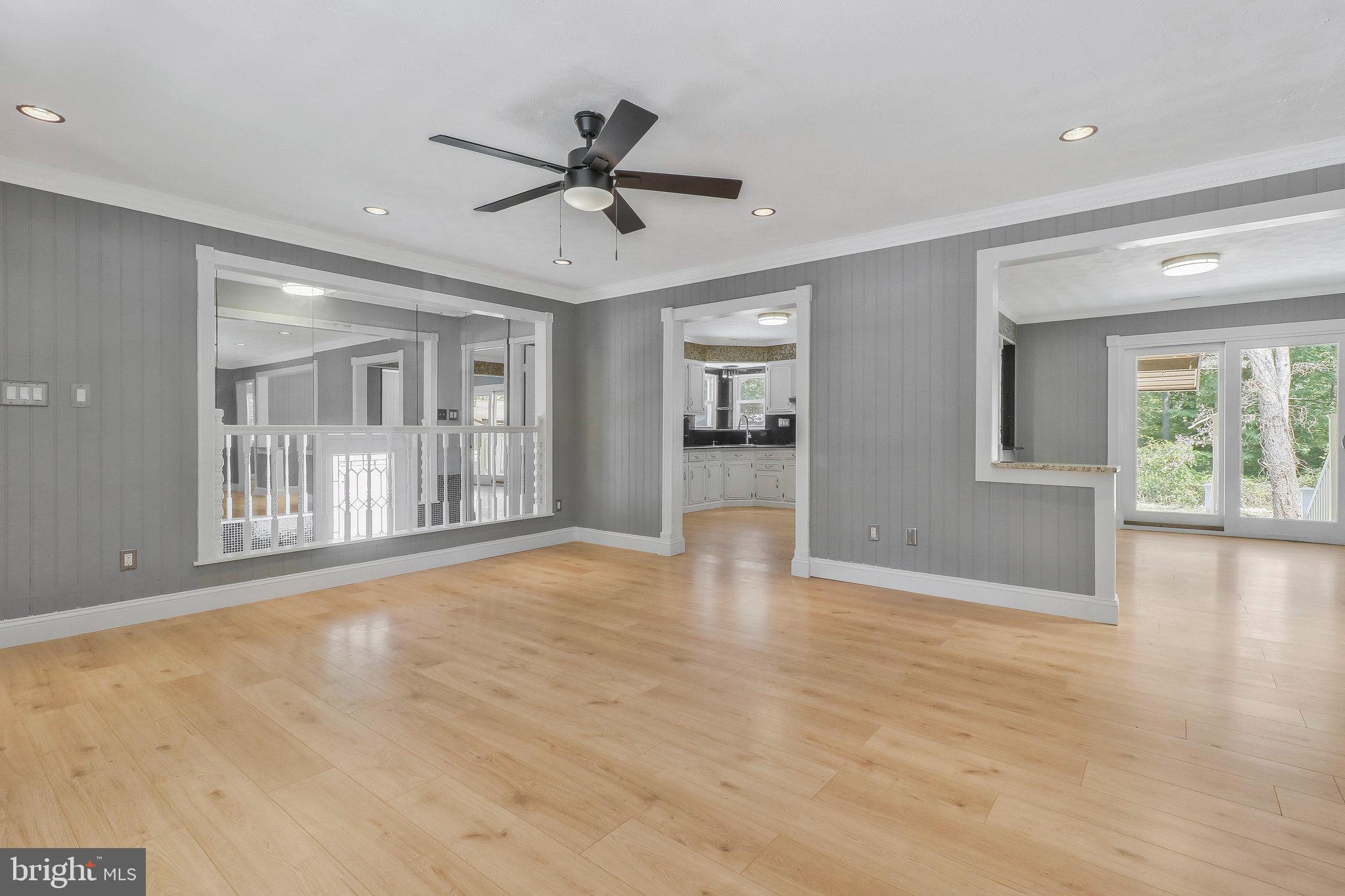 9600 Woodland Avenue Lanham, MD 20706 - Photo 7 of 41 a view of an empty room with a window and wooden floor