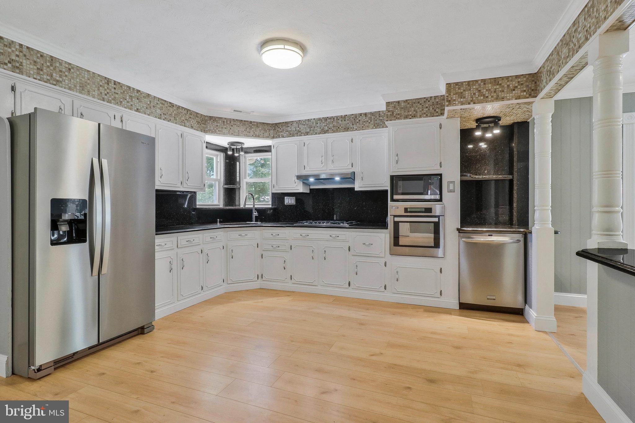 9600 Woodland Avenue Lanham, MD 20706 - Photo 8 of 41 a kitchen with stainless steel appliances a refrigerator and a stove top oven