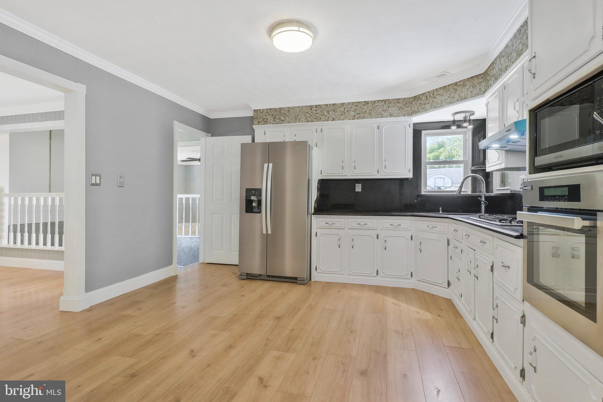 9600 Woodland Avenue Lanham, MD 20706 - Photo 9 of 41 a kitchen with granite countertop a refrigerator stove and sink