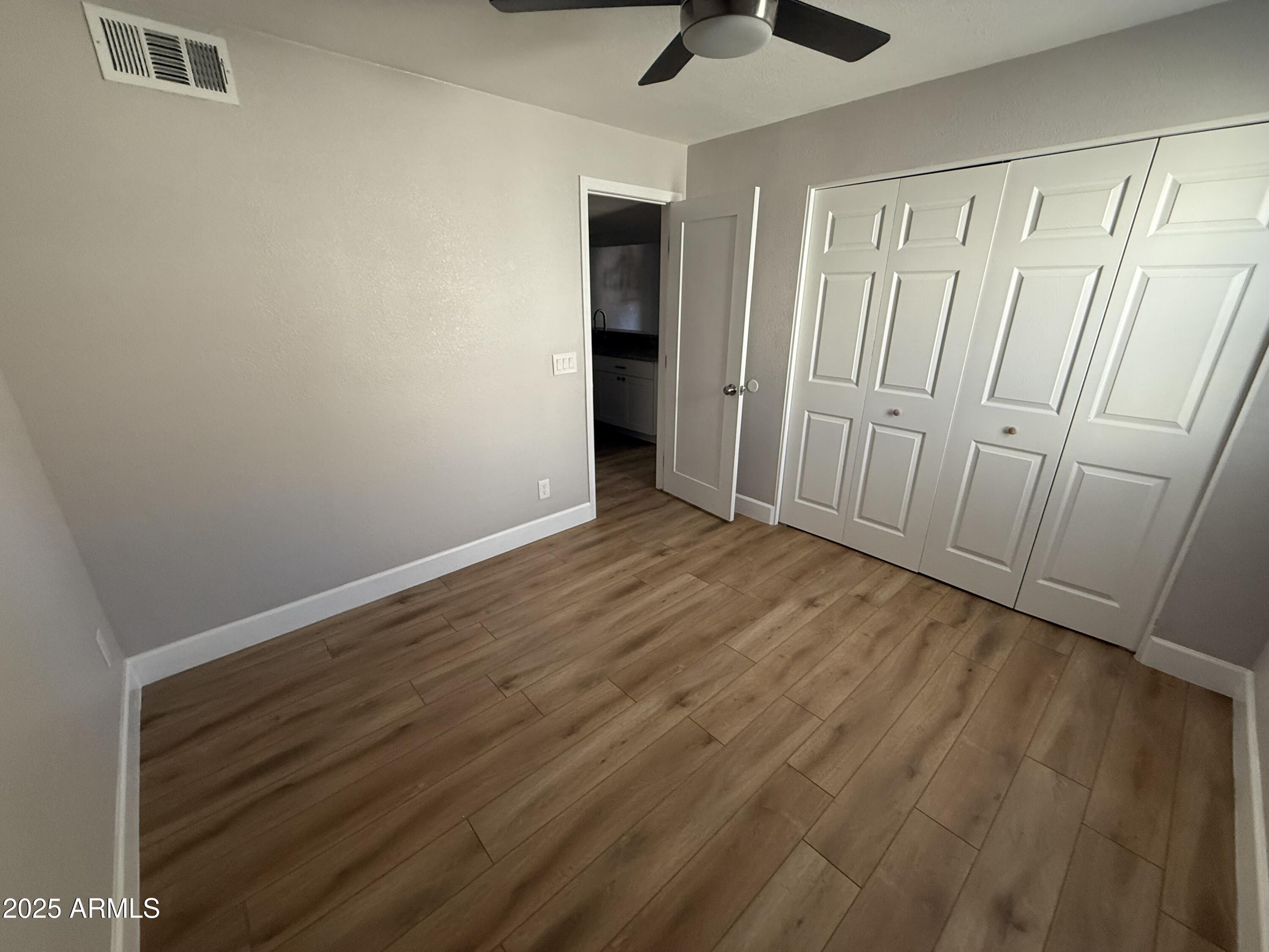 8801 North 8th Street, Unit 203 Phoenix, AZ 85020 - Photo 14 of 29 wooden floor in an empty room