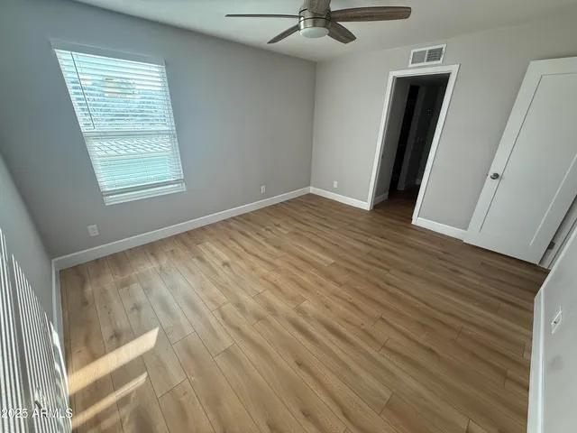 a view of a room with wooden floor and staircase