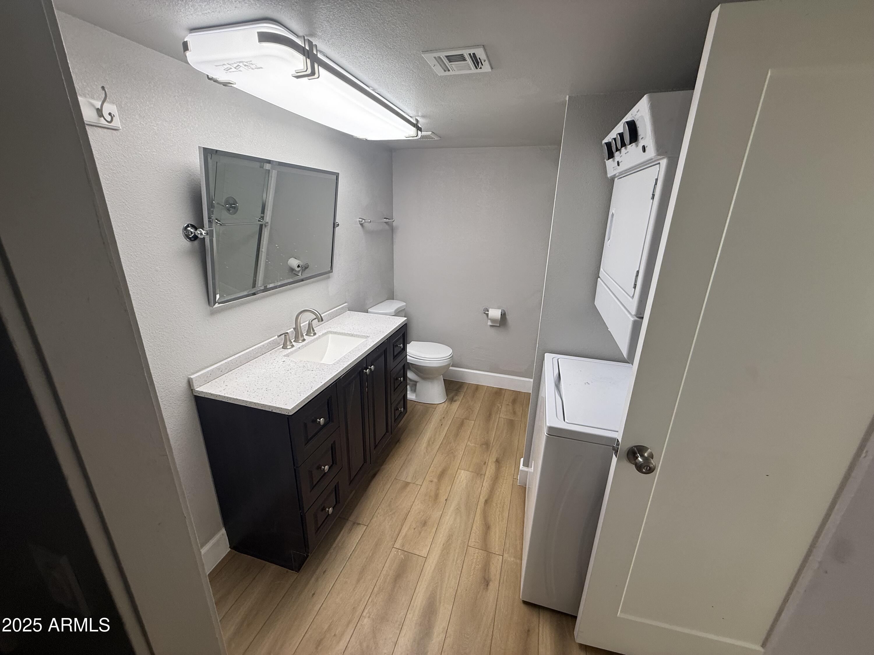 8801 North 8th Street, Unit 203 Phoenix, AZ 85020 - Photo 20 of 29 a bathroom with a sink a mirror and a toilet