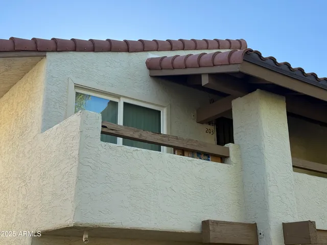 a roof deck with table and chairs