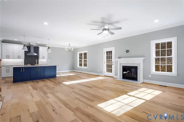 a view of livingroom with furniture a fireplace and window