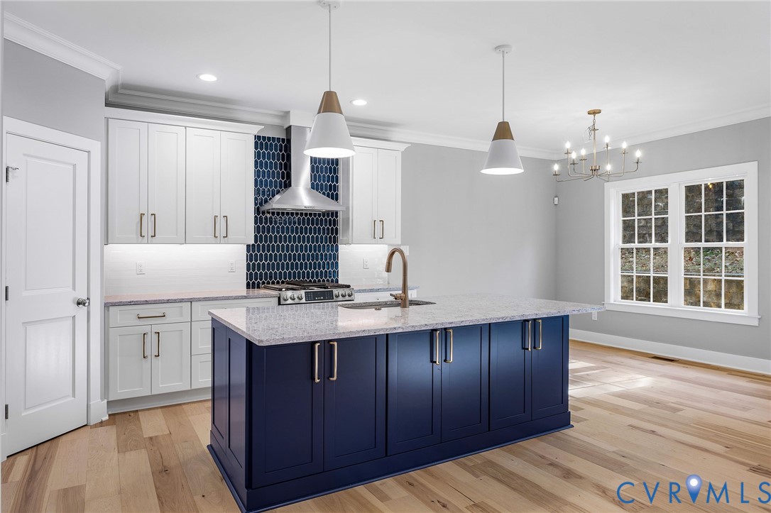 3107 Handley Road Midlothian, VA 23113 - Photo 12 of 50 a kitchen with kitchen island granite countertop a sink cabinets and wooden floor