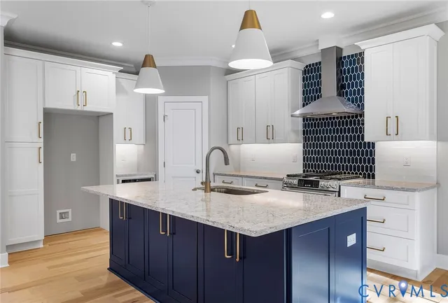 a kitchen with kitchen island granite countertop a sink and a stove