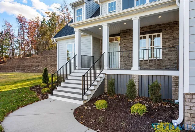 a view of a house with a yard and a garden
