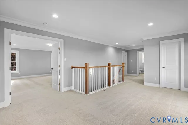 a spacious bedroom with a large bed a chandelier and windows