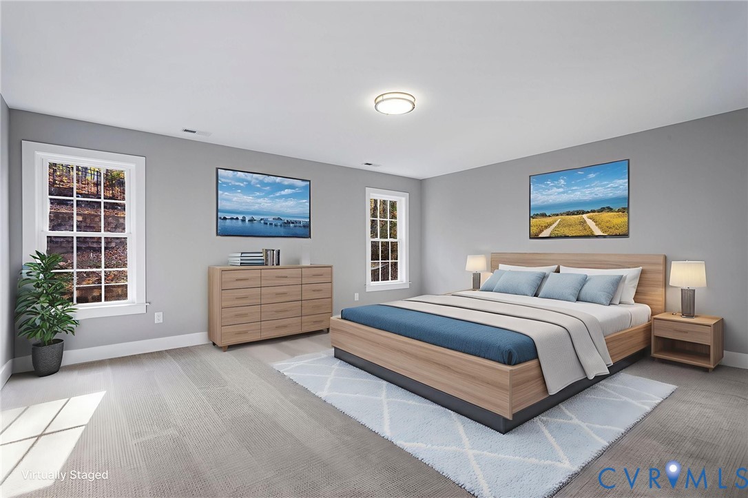 3107 Handley Road Midlothian, VA 23113 - Photo 39 of 50 a spacious bedroom with a bed a couch and windows