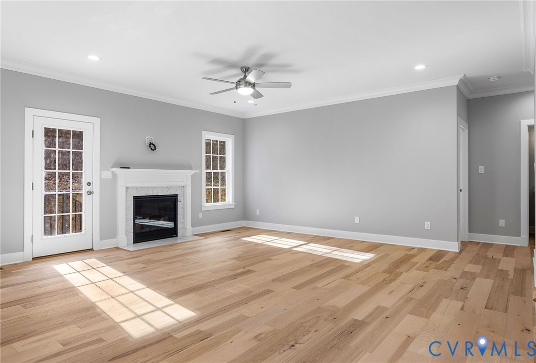 3107 Handley Road Midlothian, VA 23113 - Photo 9 of 50 a view of an empty room with wooden floor fireplace and a window