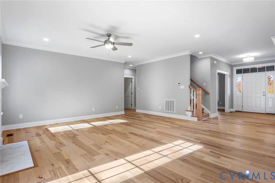 3107 Handley Road Midlothian, VA 23113 - Photo 10 of 50 a view of an empty room with wooden floor and a ceiling fan