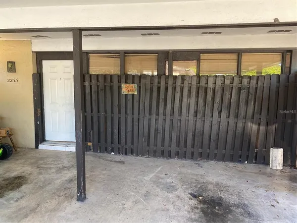a view of a house with a wooden fence