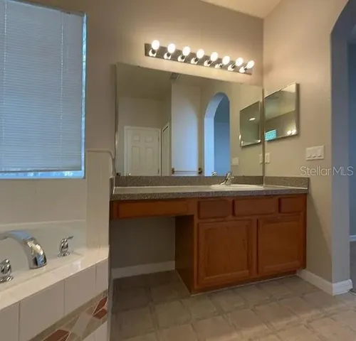 a bathroom with a double vanity sink and a mirror