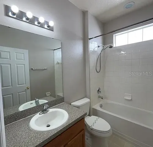 a bathroom with a sink toilet tub and shower