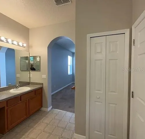a spacious bathroom with a double vanity sink and a mirror