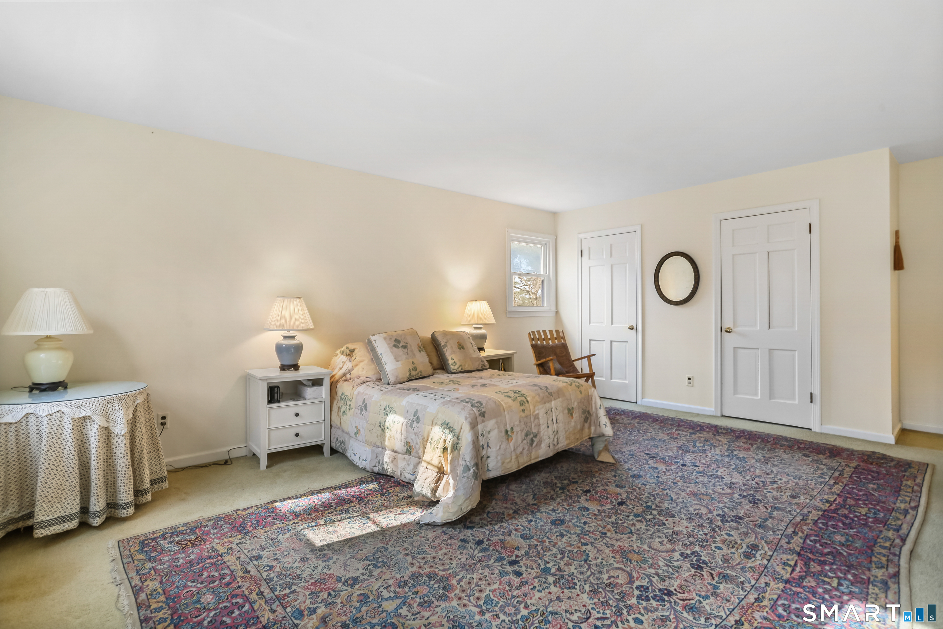 268 Umpawaug Road Redding, CT 06896 - Photo 11 of 28 a spacious bedroom with a bed and a lamp