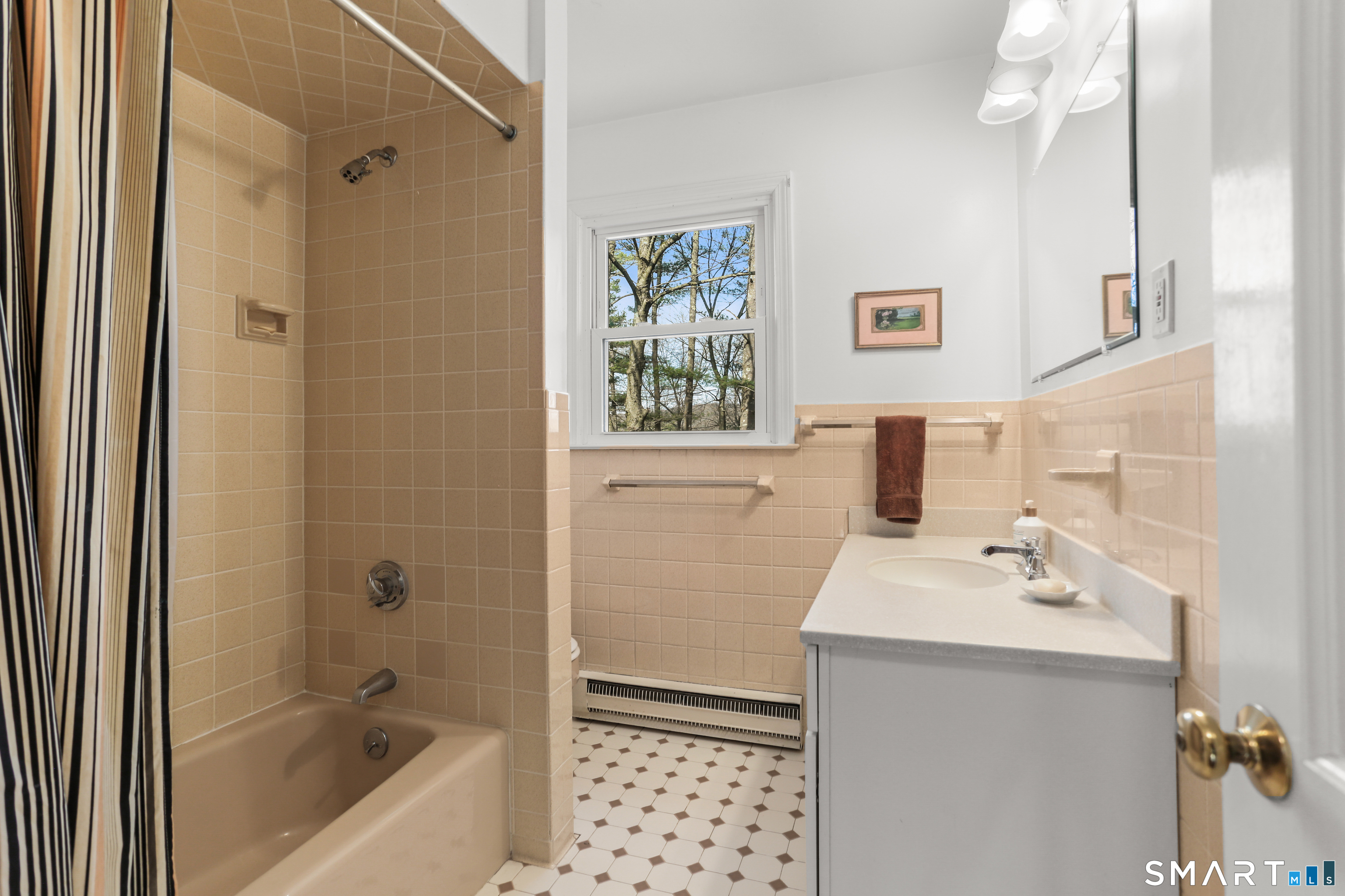 268 Umpawaug Road Redding, CT 06896 - Photo 16 of 28 a bathroom with a sink a mirror a bathtub and shower