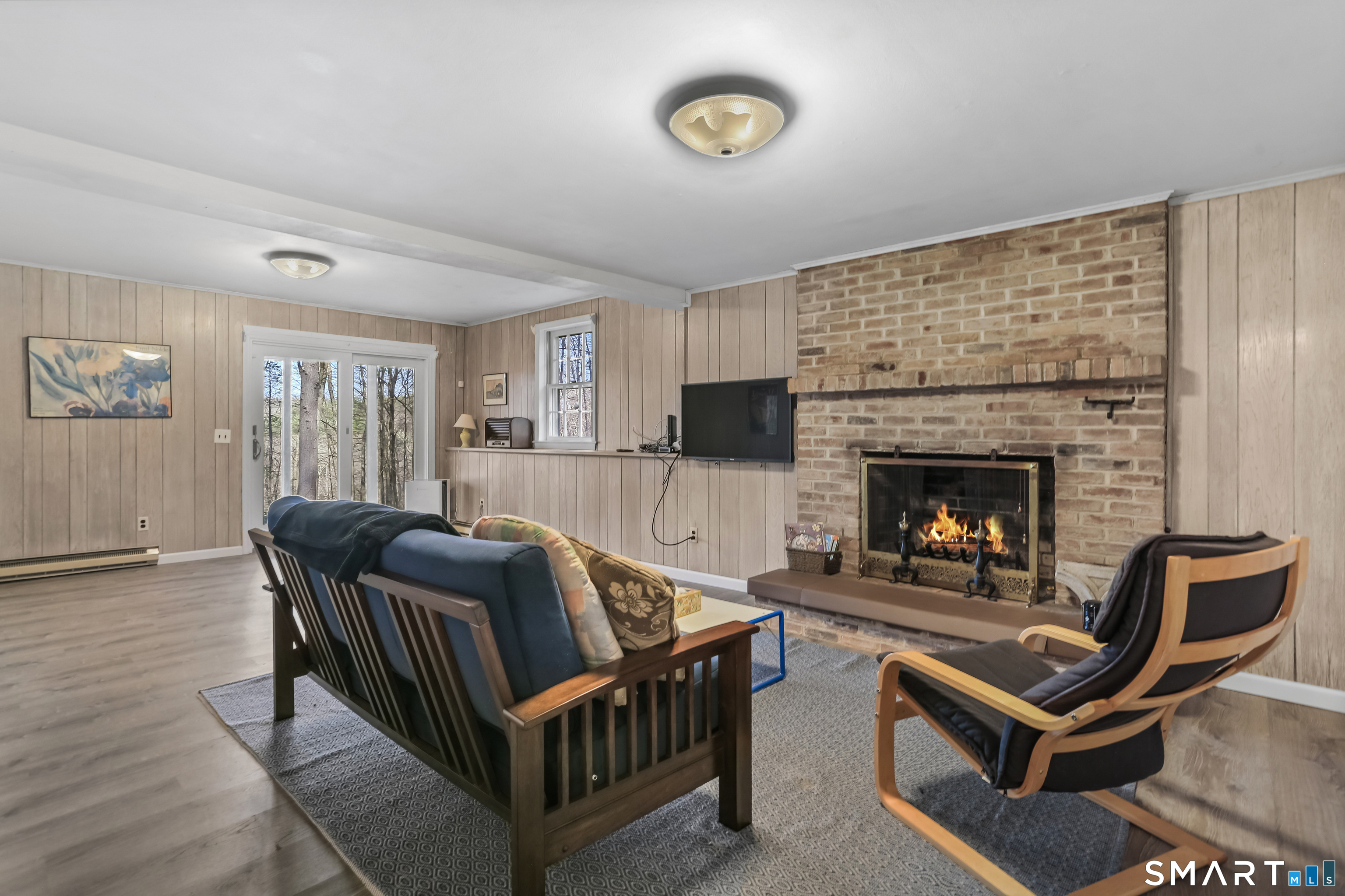 268 Umpawaug Road Redding, CT 06896 - Photo 18 of 28 a living room with furniture and a fireplace