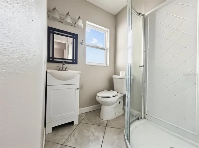 a bathroom with a sink a mirror and shower