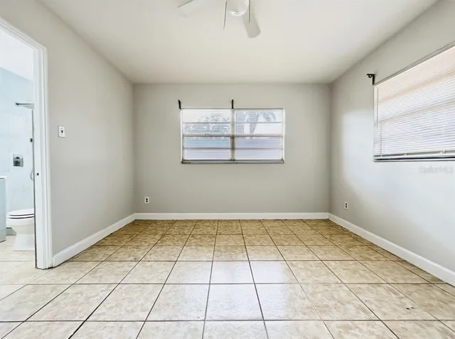 a kitchen with white cabinets and appliances
