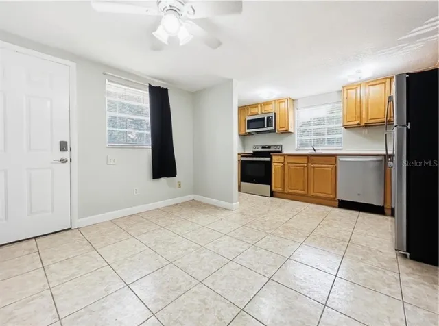 a view of an empty room with window and cabinet