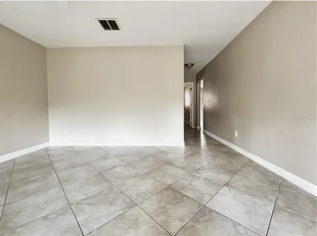 a kitchen with granite countertop a stove a sink and a refrigerator