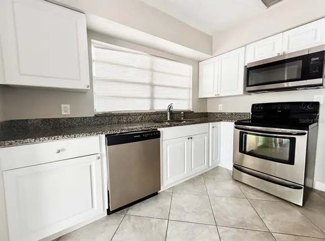 a bathroom with a shower sink vanity and mirror