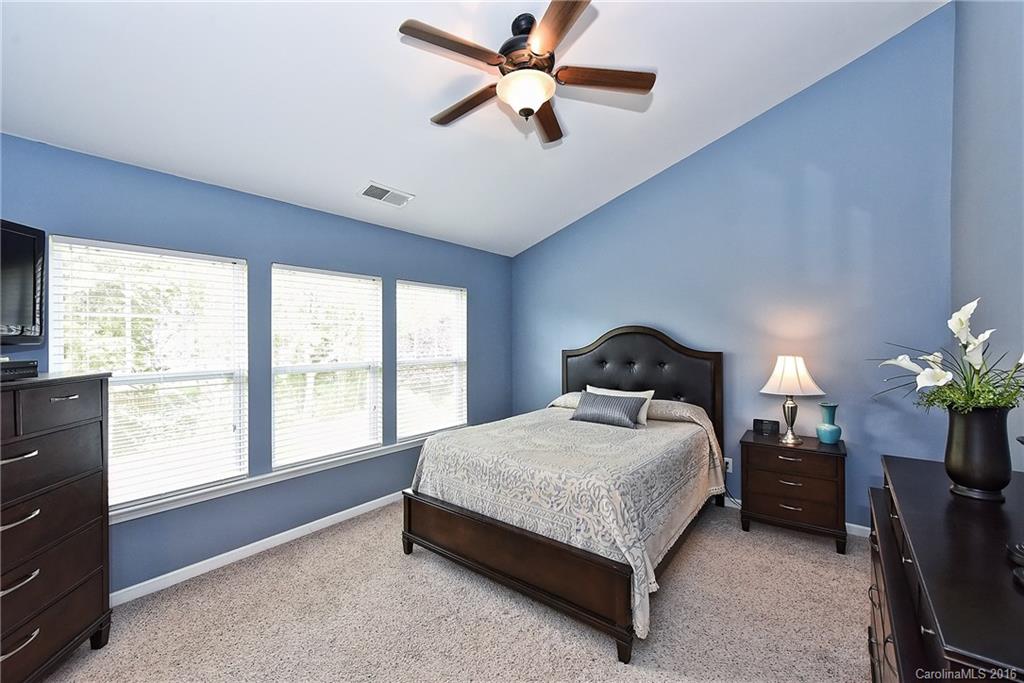 142 Whitley Mills Road Fort Mill, SC 29708 - Photo 12 of 24 a spacious bedroom with a bed chandelier and a window