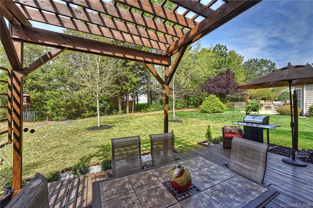 142 Whitley Mills Road Fort Mill, SC 29708 - Photo 17 of 24 a view of a patio with table and chairs potted plants with wooden floor and fence