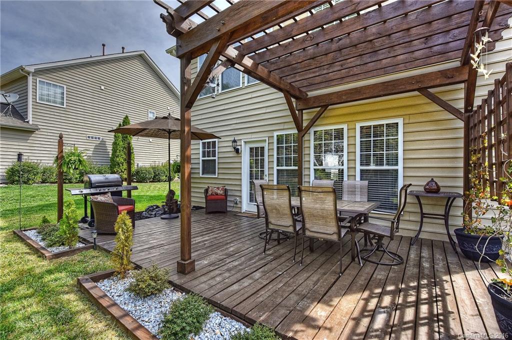 142 Whitley Mills Road Fort Mill, SC 29708 - Photo 18 of 24 a view of a patio with table and chairs with wooden floor and fence