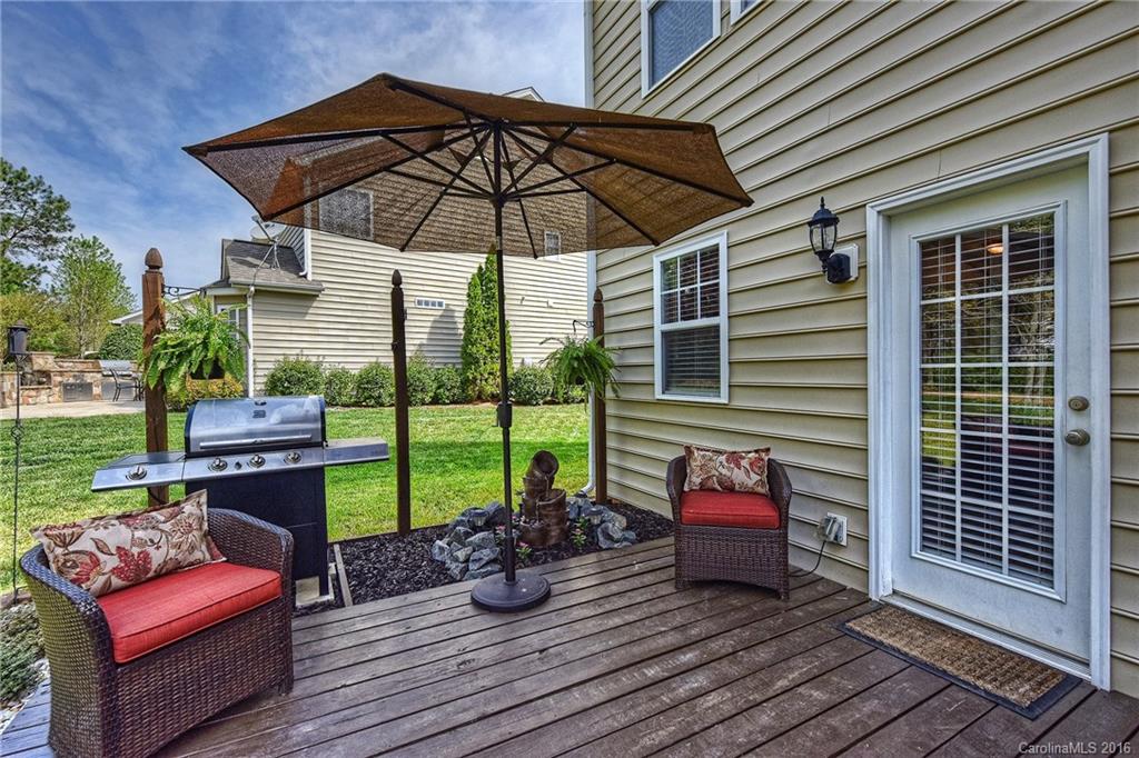 142 Whitley Mills Road Fort Mill, SC 29708 - Photo 19 of 24 a view of a deck with couches under an umbrella