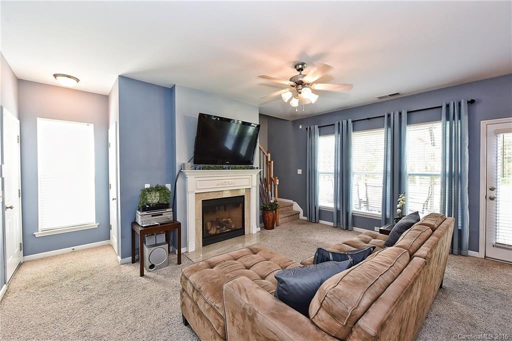 142 Whitley Mills Road Fort Mill, SC 29708 - Photo 4 of 24 a living room with furniture a fireplace and a flat screen tv