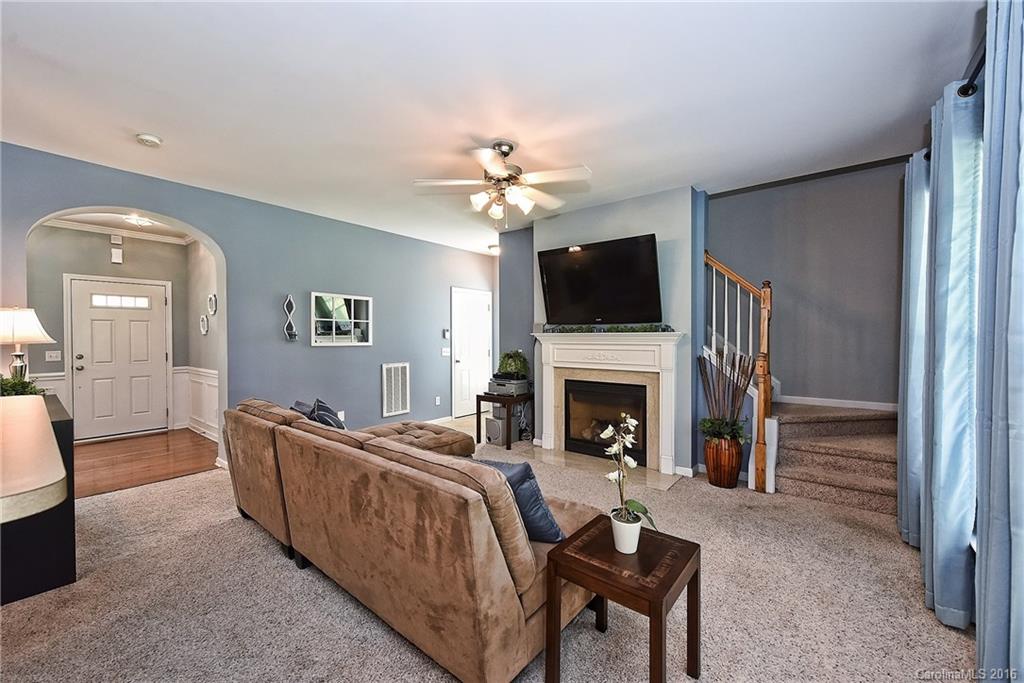 142 Whitley Mills Road Fort Mill, SC 29708 - Photo 5 of 24 a living room with furniture a fireplace and a flat screen tv