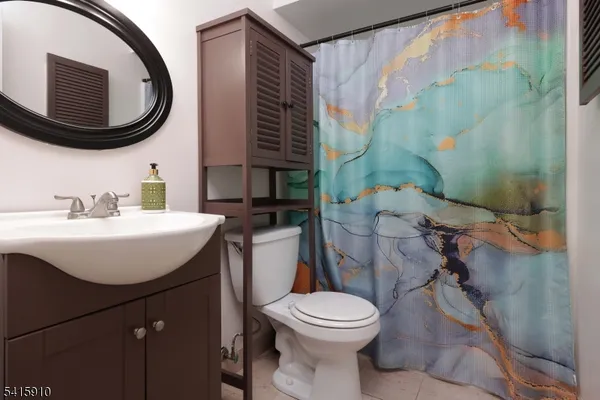 a bathroom with a sink a toilet and a mirror