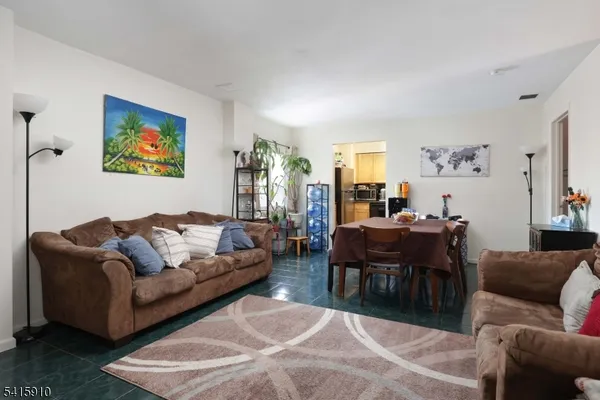 a living room with furniture a rug and a window