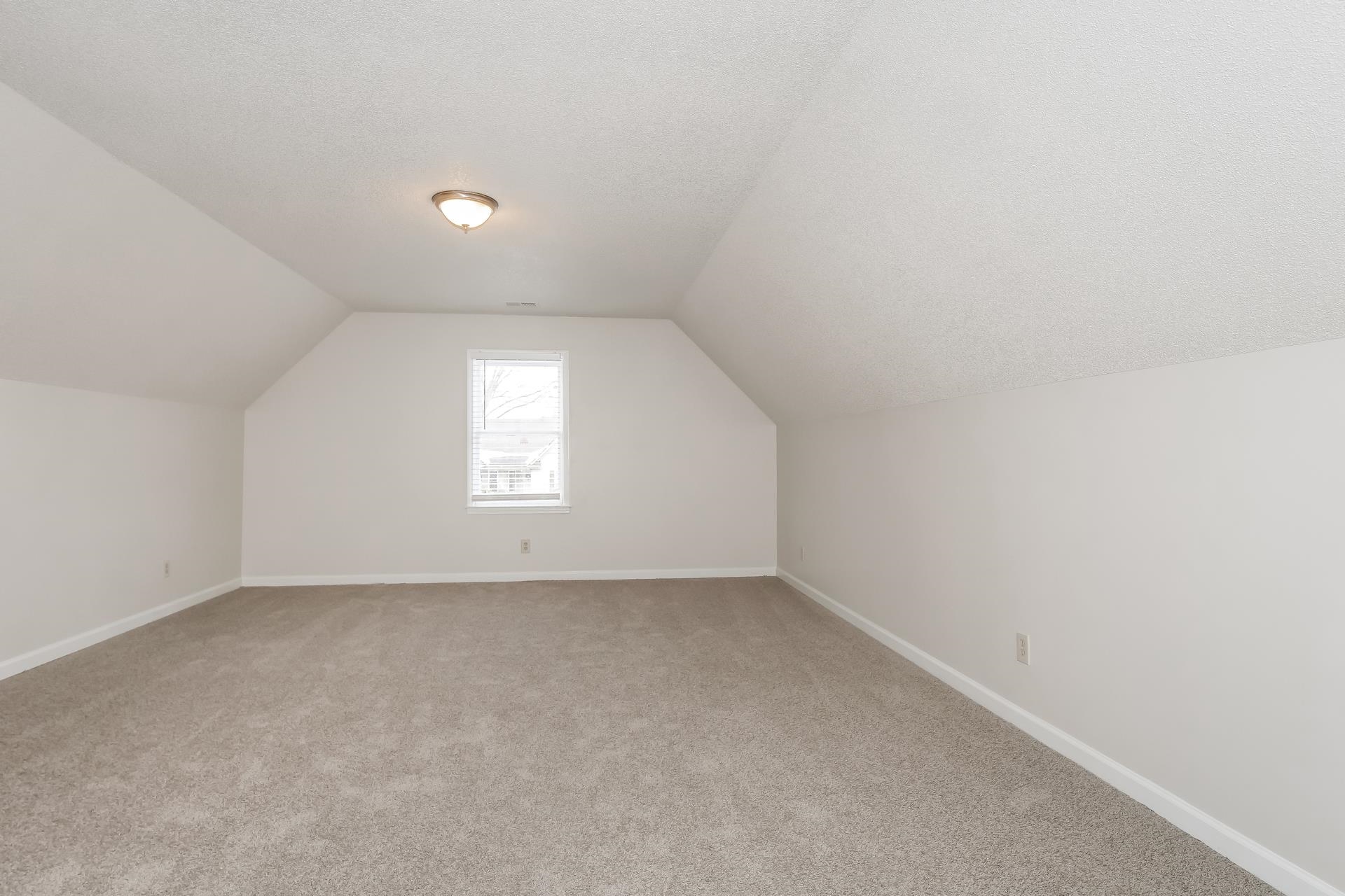 675 South Collierville Arlington Road Collierville, TN 38017 - Photo 11 of 17 Additional living space with a textured ceiling and light colored carpet