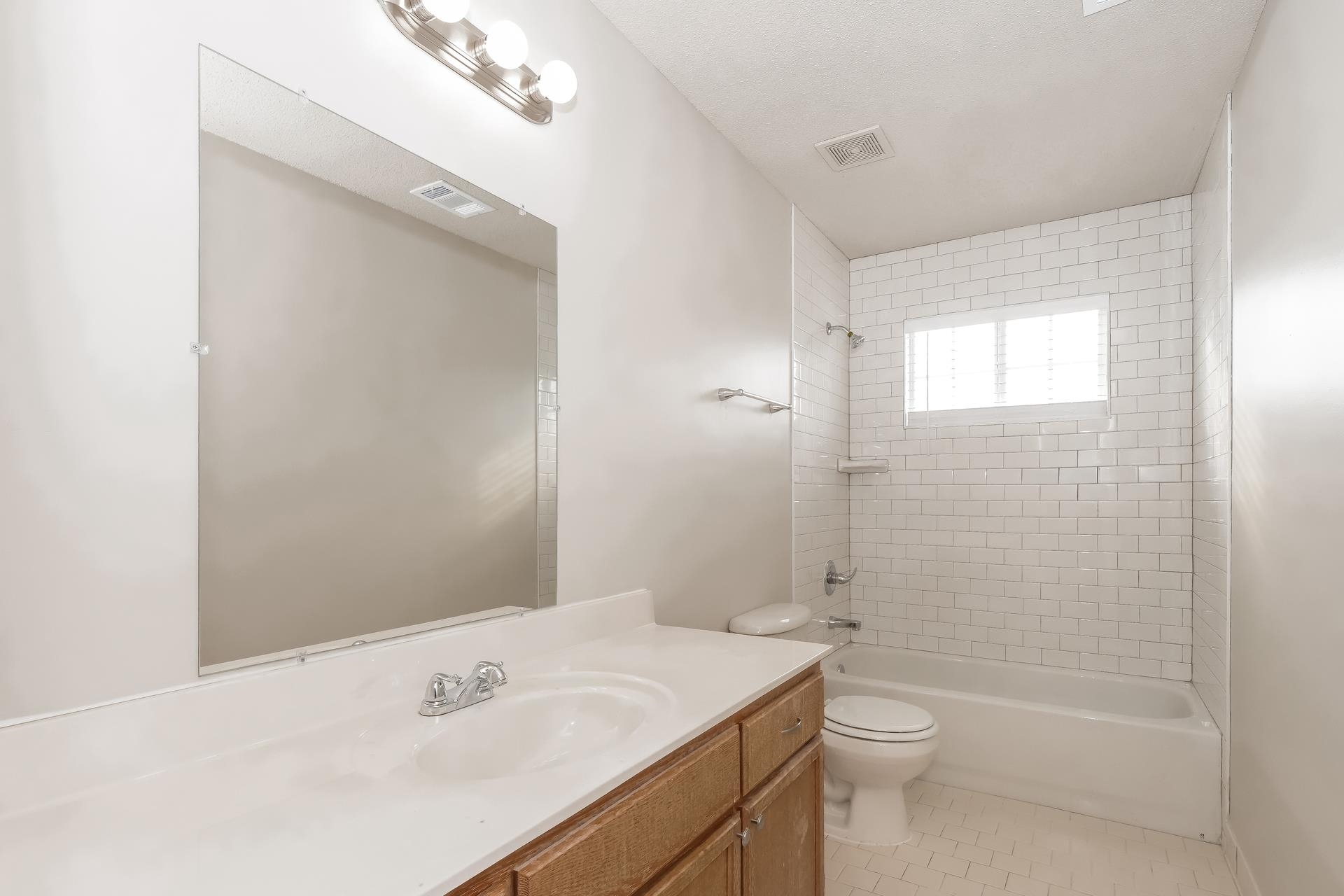 675 South Collierville Arlington Road Collierville, TN 38017 - Photo 12 of 17 Bathroom featuring shower / bath combination, vanity, and light tile patterned flooring