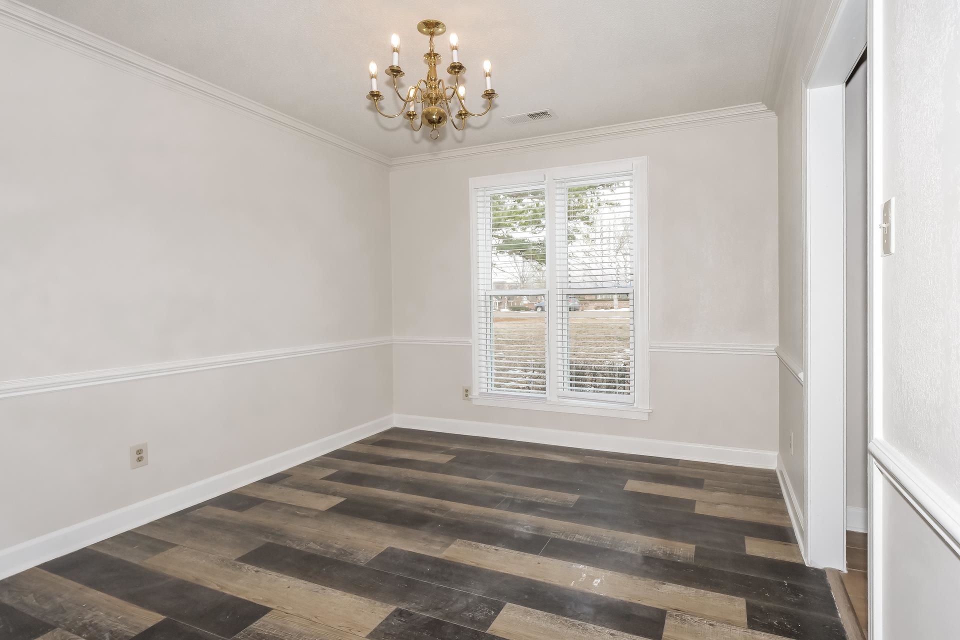 675 South Collierville Arlington Road Collierville, TN 38017 - Photo 4 of 17 Unfurnished dining area with dark wood-style floors, suspended lighting, and crown molding