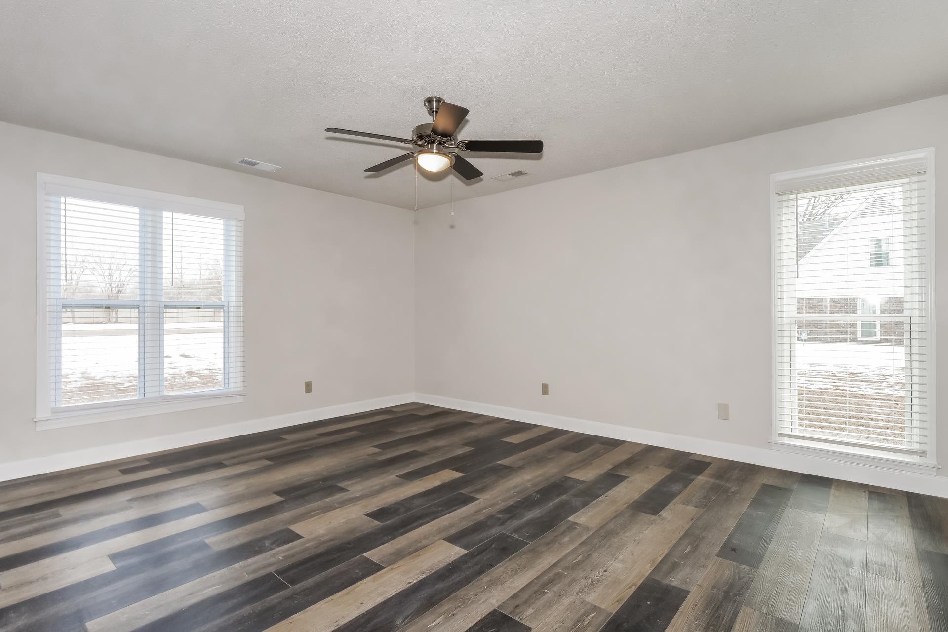 675 South Collierville Arlington Road Collierville, TN 38017 - Photo 7 of 17 Unfurnished room with dark wood-style flooring and ceiling fan