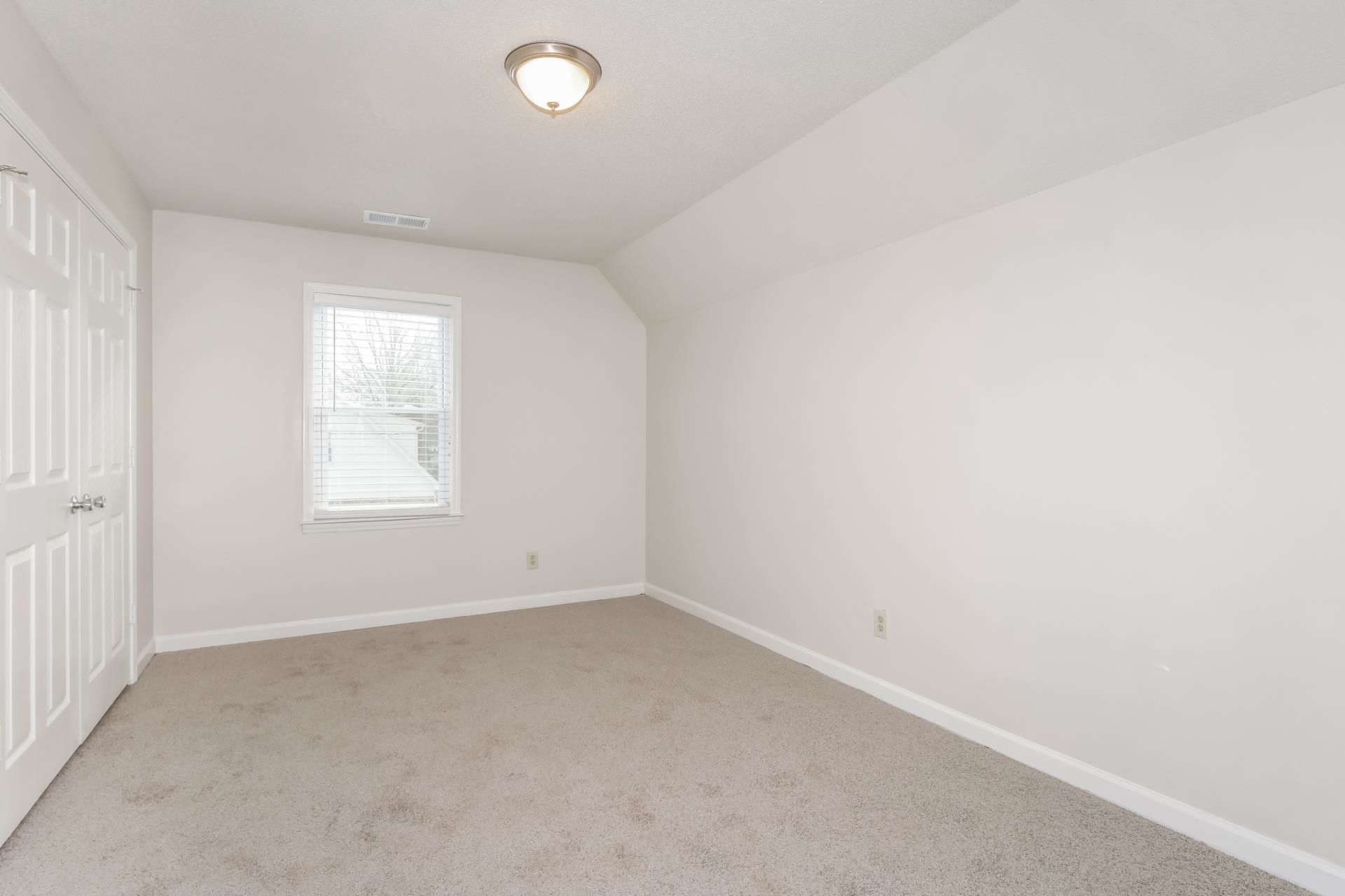 675 South Collierville Arlington Road Collierville, TN 38017 - Photo 9 of 17 Additional living space featuring light colored carpet and lofted ceiling