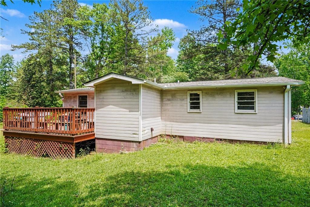 137 Taylor Road Jackson, GA 30233 - Photo 18 of 23 a backyard of a house with wooden deck and seating space