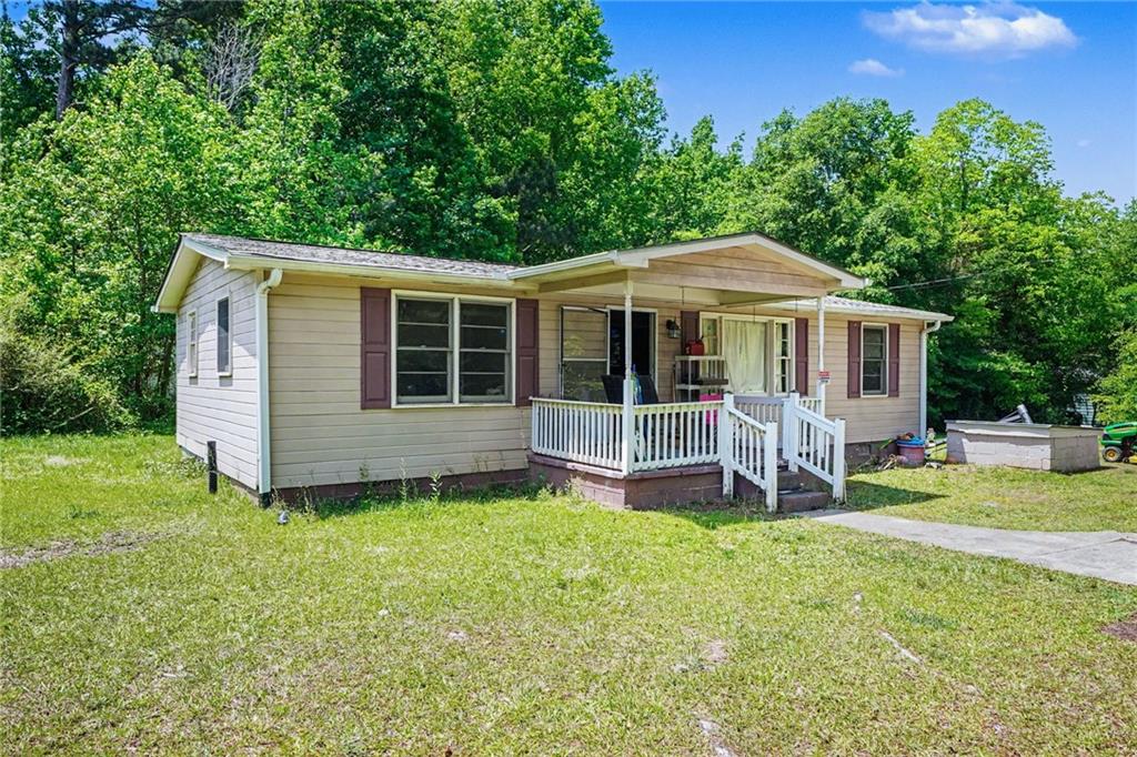137 Taylor Road Jackson, GA 30233 - Photo 2 of 23 a front view of a house with a yard table and chairs