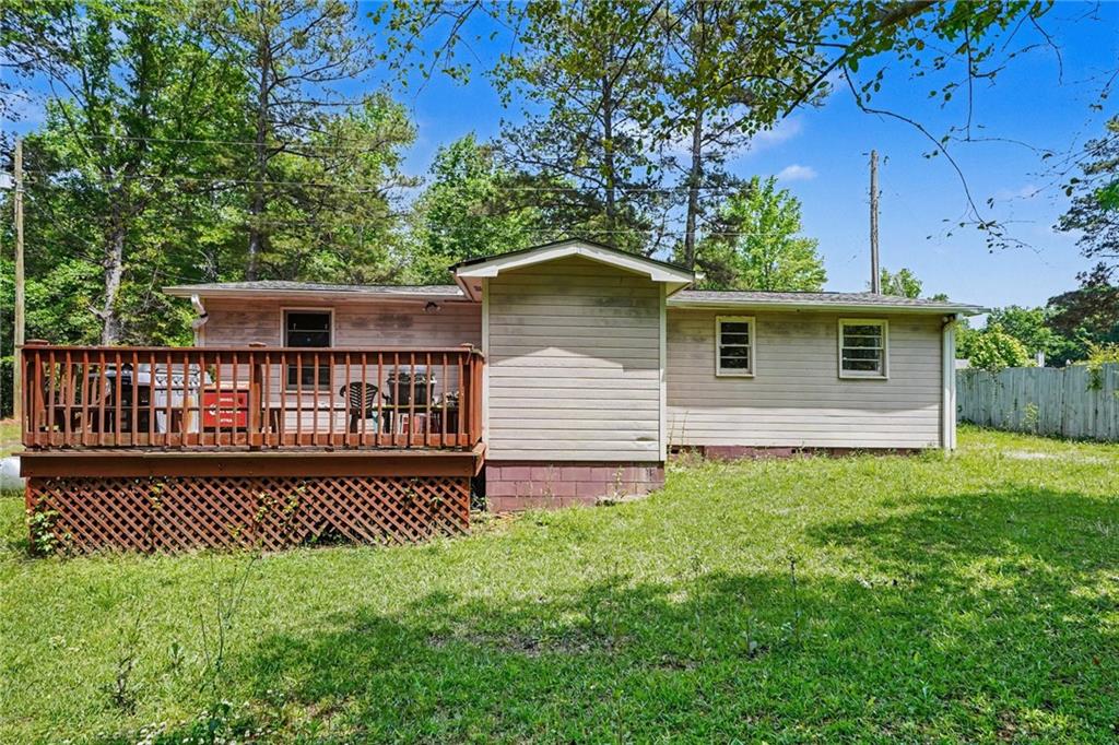 137 Taylor Road Jackson, GA 30233 - Photo 21 of 23 a view of a house with a small yard plants and large tree