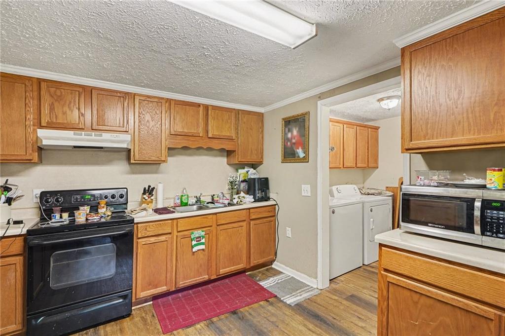 137 Taylor Road Jackson, GA 30233 - Photo 8 of 23 a kitchen with a stove a sink and a microwave