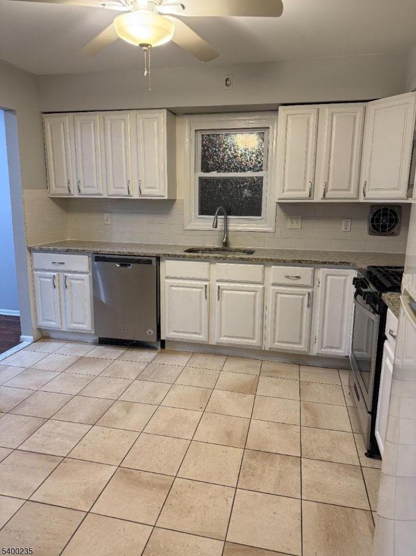 a kitchen with a sink window and cabinets