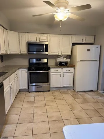 a kitchen with a stove top oven and cabinets