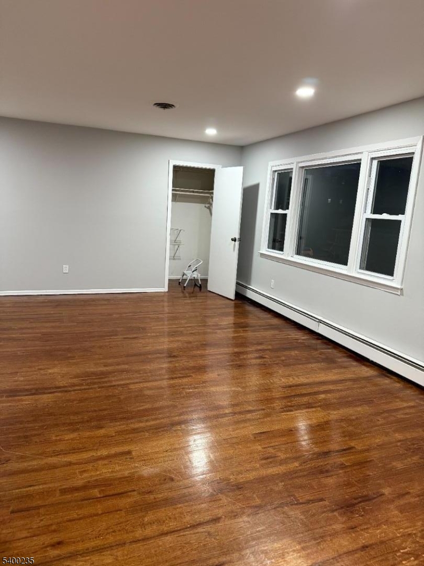 116 West Linden Avenue Linden, NJ 07036 - Photo 3 of 9 a view of an empty room with wooden floor and a window